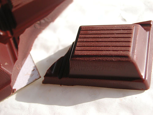 A piece of dark chocolate A piece of dark chocolate